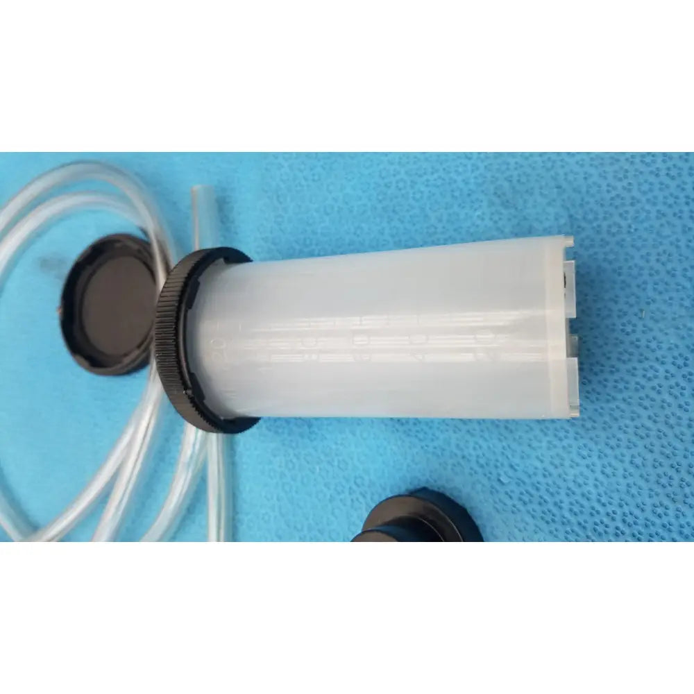 White translucent plastic cylindrical filter with black threaded cap and clear tubing in mityvac mv8500 elite automotive kit