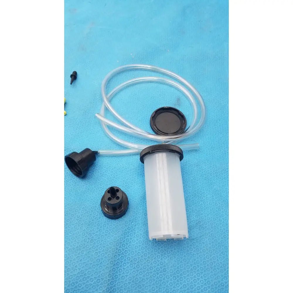 Clear plastic syringe-style fluid reservoir with black threaded cap and tube in mityvac mv8500 elite automotive kit