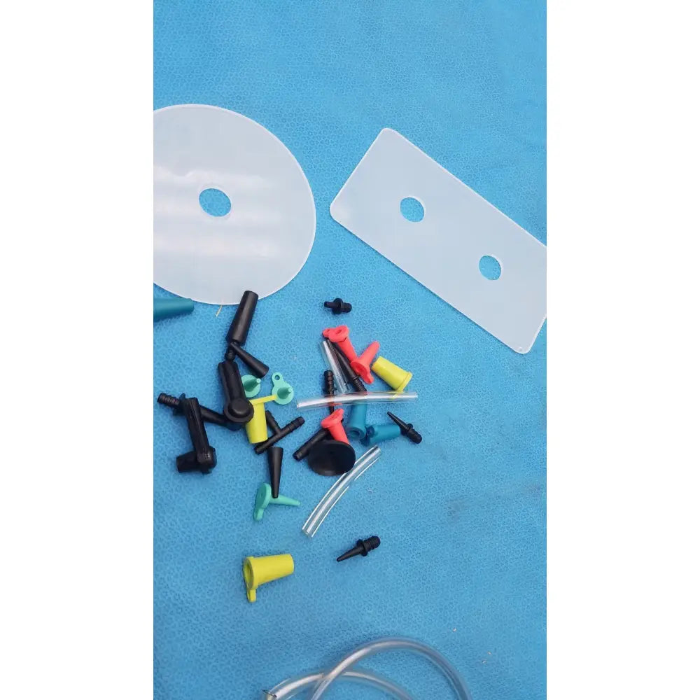A collection of colorful plastic medical tubing connectors and adapters for the mityvac mv8500 elite automotive kit