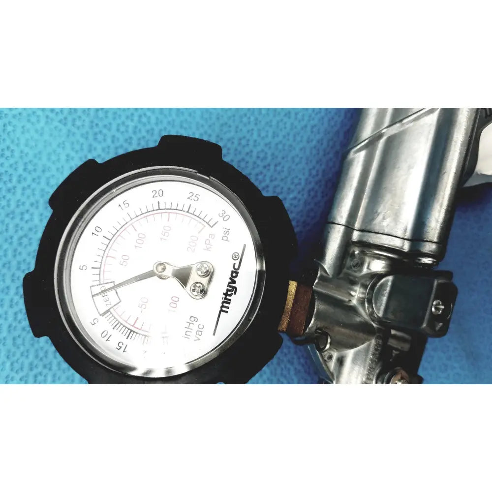 Black-rimmed pressure gauge with white face and silver needle in the mityvac mv8500 elite automotive kit