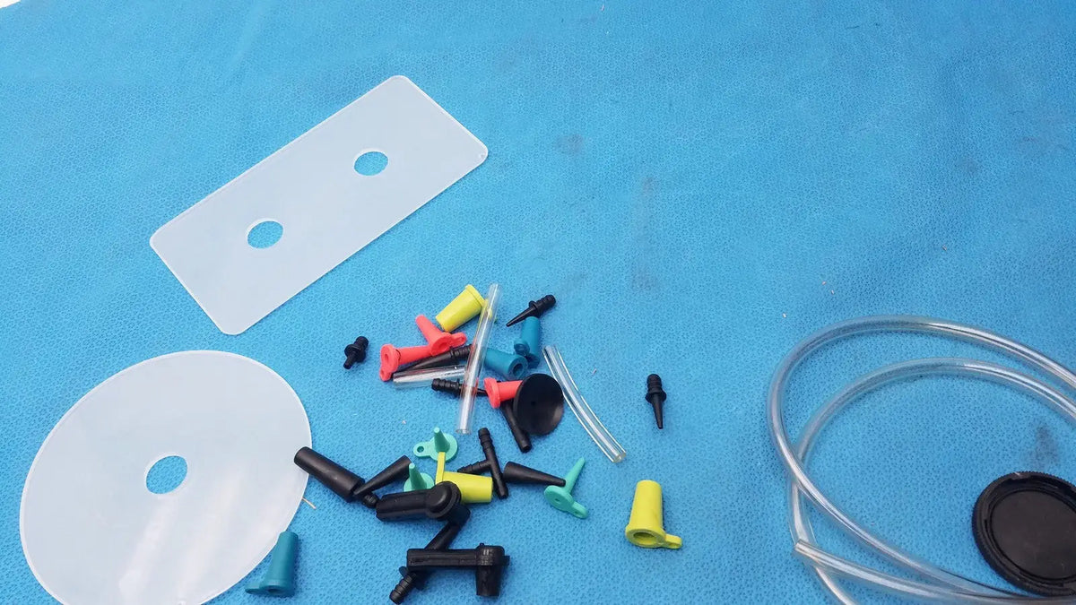 A collection of colorful plastic and silicone tubing connectors caps and adapters for mityvac mv8500 elite automotive kit