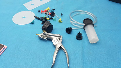 Silver-handled hydraulic pump with black accents and transparent fluid reservoir in mityvac mv8500 elite automotive kit