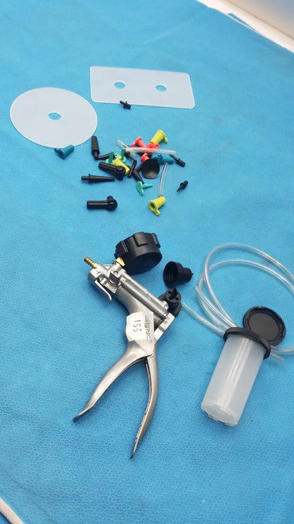 Silver-handled medical syringe pump with black caps clear tubing and colored connectors in mityvac mv8500 elite automotive kit
