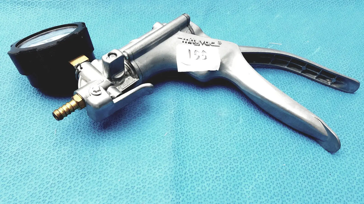 Silver metallic milivac vacuum pump with black pressure gauge and ergonomic handles in mityvac mv8500 elite automotive kit