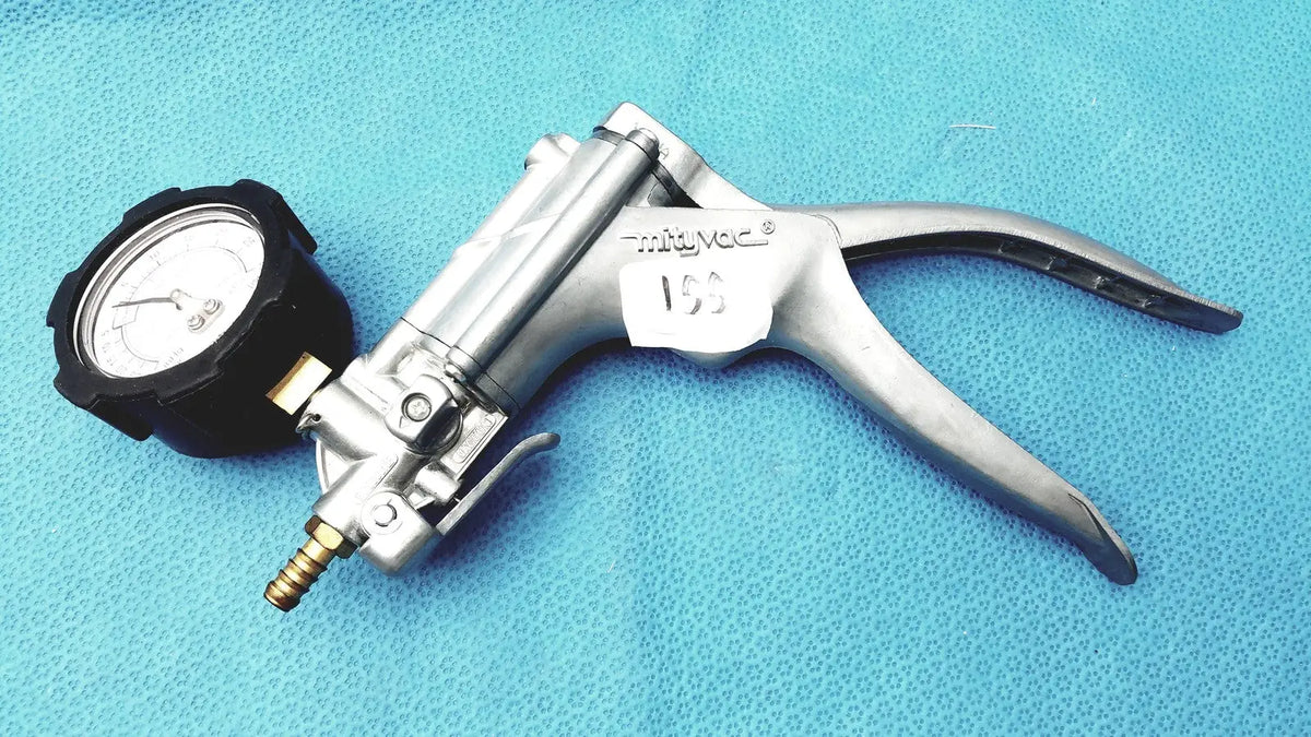 Silver metallic surgical vacuum pump with black pressure gauge and brass fittings in mityvac mv8500 elite automotive kit