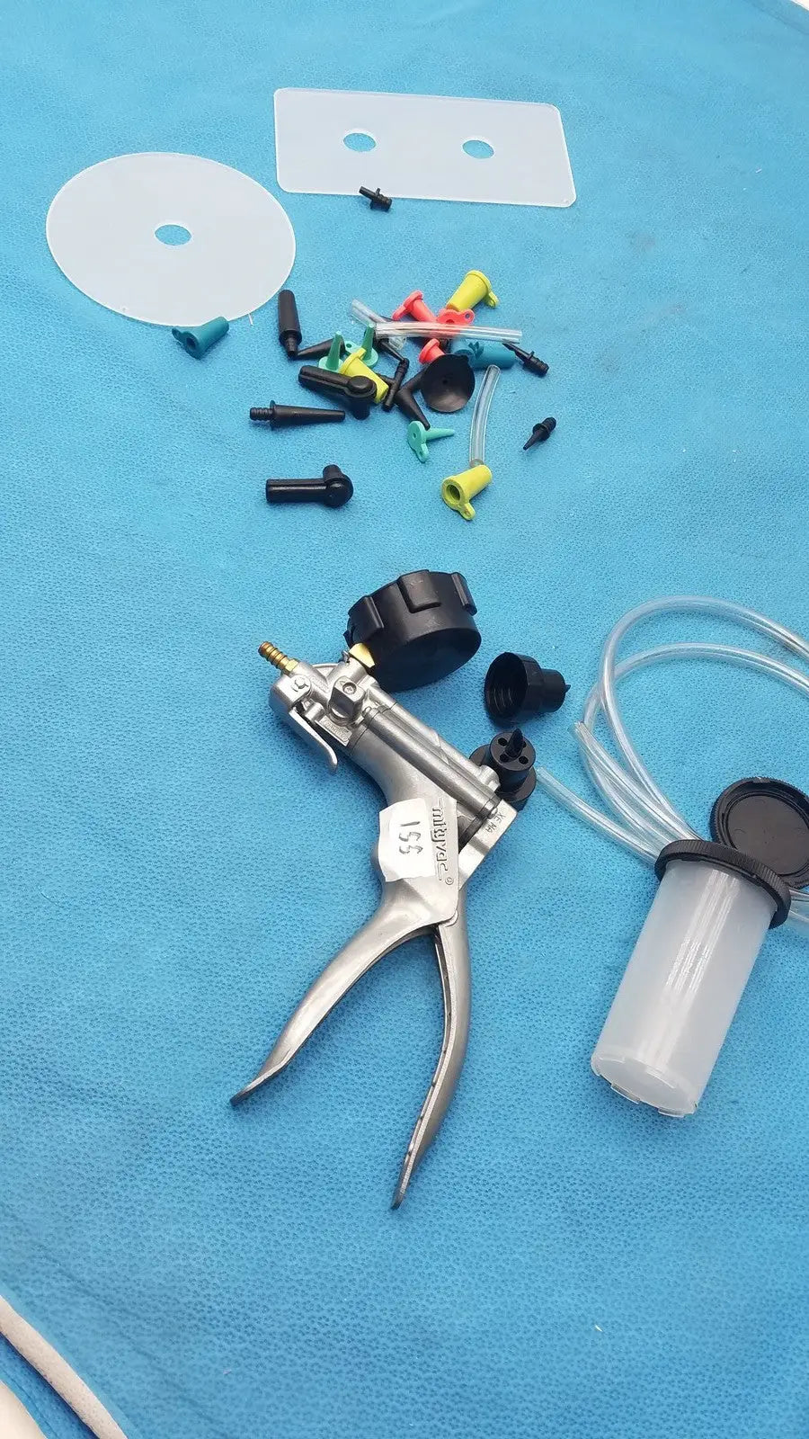 Silver surgical syringe pump with black knobs and clear fluid reservoir in the mityvac mv8500 elite automotive kit