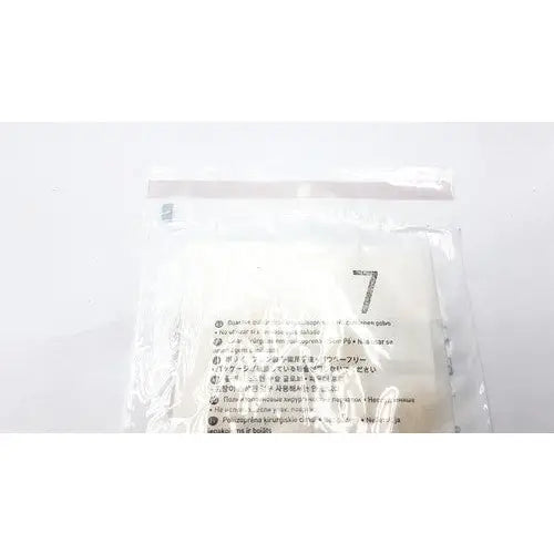 A clear plastic bag with white soft filter papers and multilingual instructions for molnlycke biogel pl surgical gloves size 7