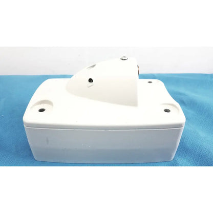White plastic monitor mounting arm with slightly curved top and four mounting holes for secure installation