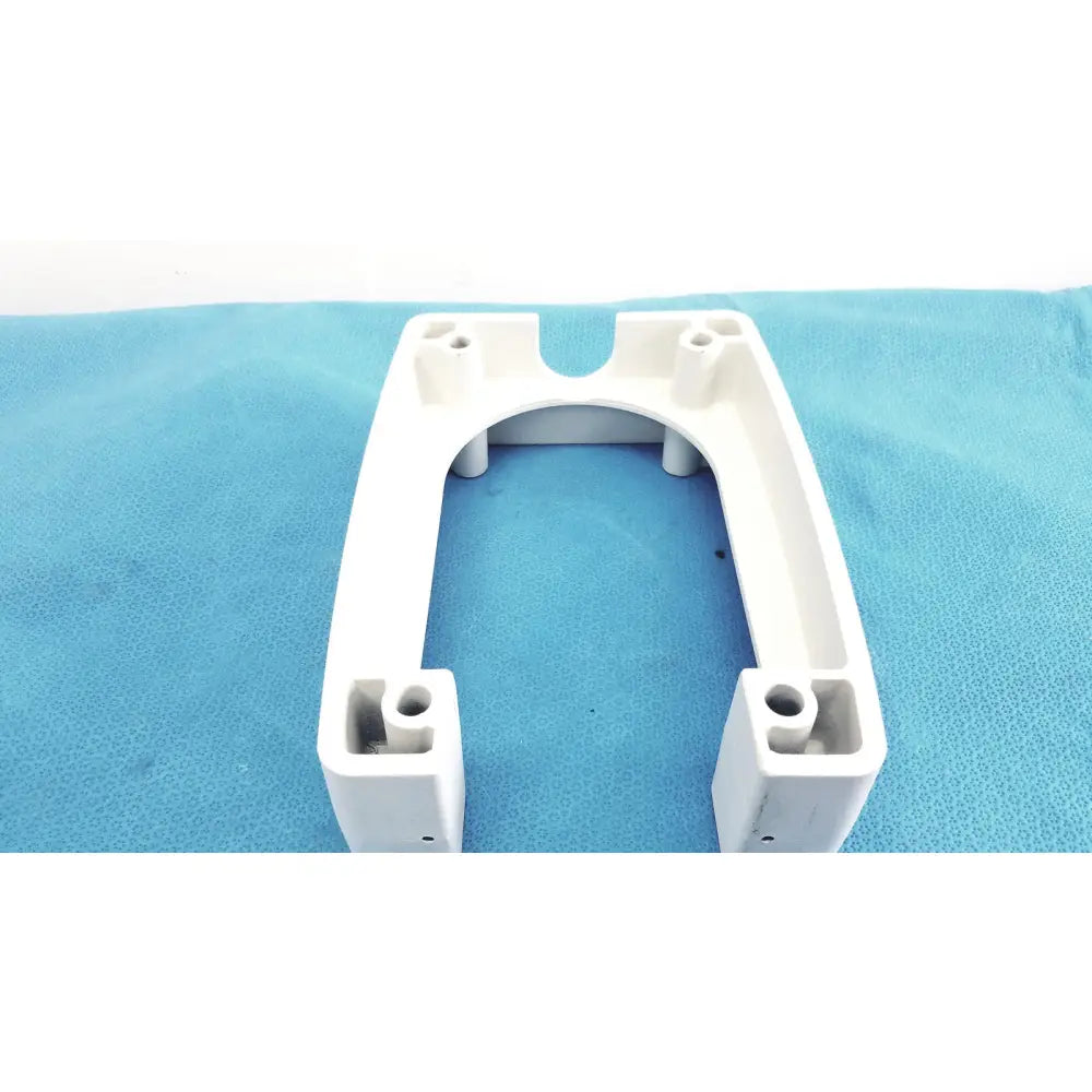 White plastic u-shaped monitor mounting arm bracket with molded holes and cutouts for secure attachment