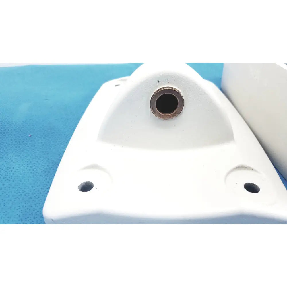 White plastic monitor mounting arm bracket with central circular hole and two smaller corner holes for secure attachment