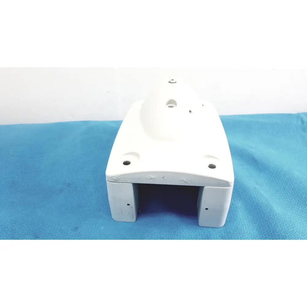 White plastic housing with rounded edges and multiple mounting holes for monitor mounting arm plastic brackets