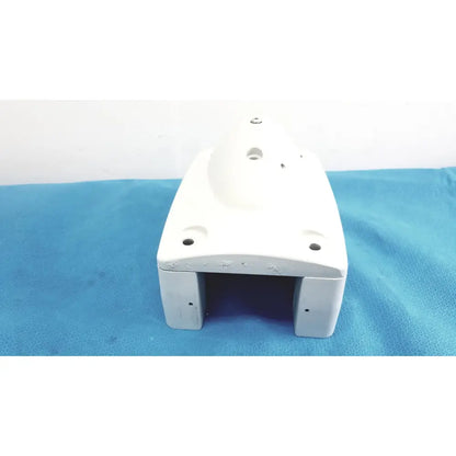 White plastic housing with rounded edges and multiple mounting holes for monitor mounting arm plastic brackets