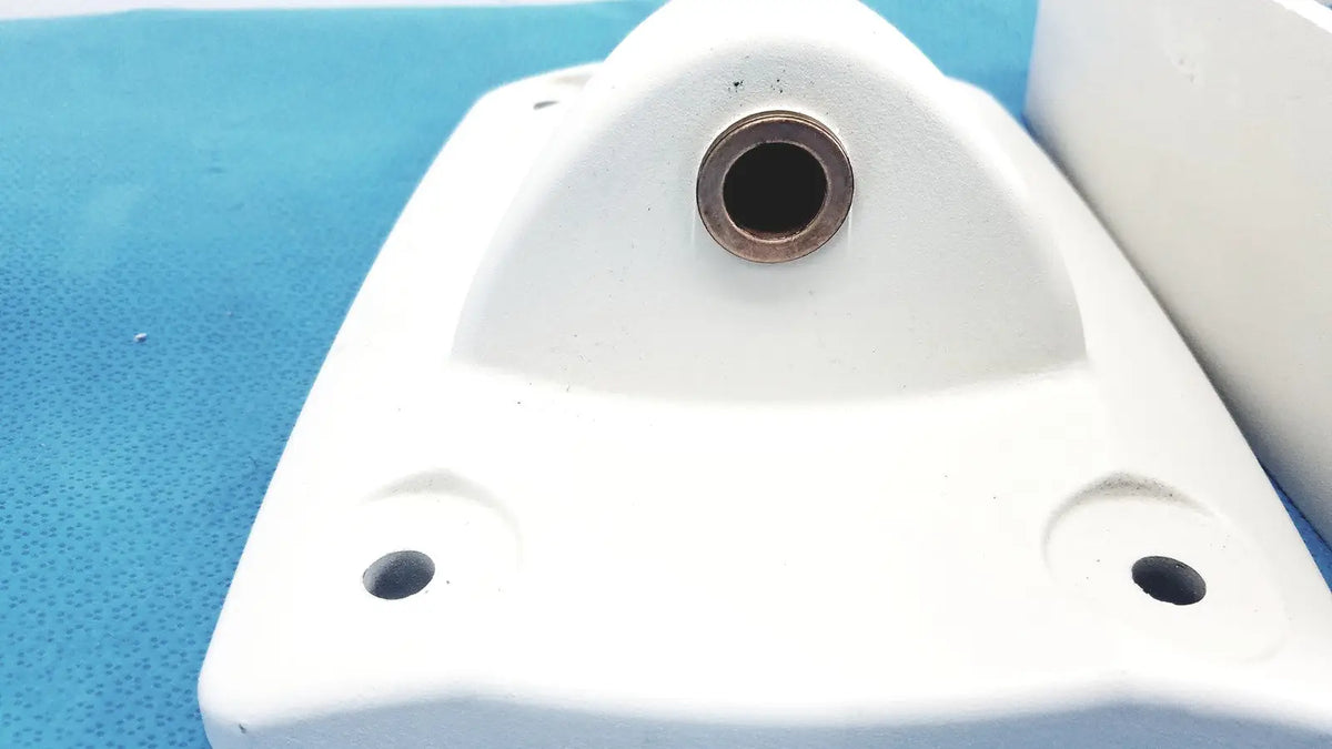 White plastic monitor mounting arm bracket with central circular hole and two smaller corner holes for secure attachment