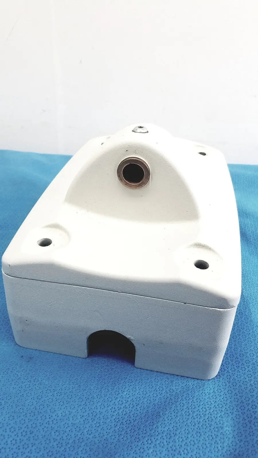 White mounting arm plastic housing with circular top opening and rectangular bottom cutout for monitor mounting arm brackets