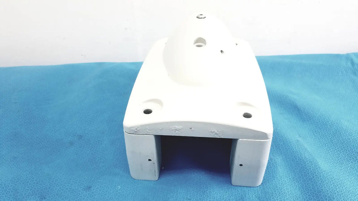 White plastic housing with rounded edges and multiple mounting holes for monitor mounting arm plastic brackets