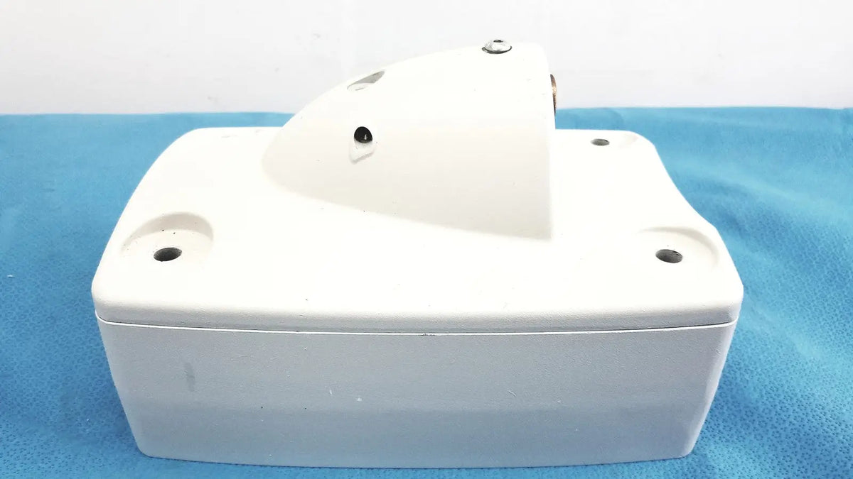 White plastic monitor mounting arm with slightly curved top and four mounting holes for secure installation