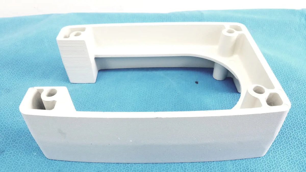White plastic u-shaped monitor mounting arm bracket with integrated mounting holes and textured edges