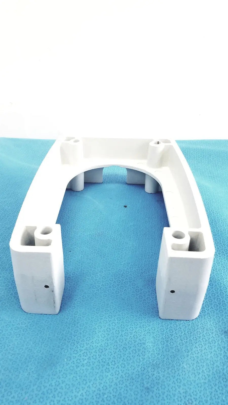 White plastic u-shaped bracket with molded supports and mounting holes for monitor mounting arm plastic white brackets