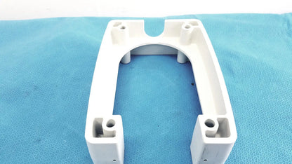White plastic u-shaped monitor mounting arm bracket with molded holes and cutouts for secure attachment