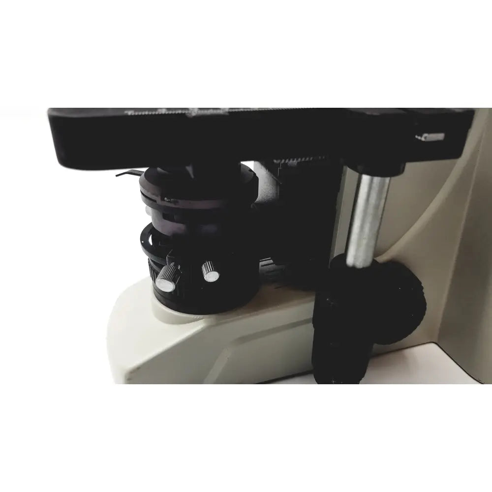 Black microscope stage with metallic adjustment knobs and silver vertical column on motic ba300 biological microscope tested model