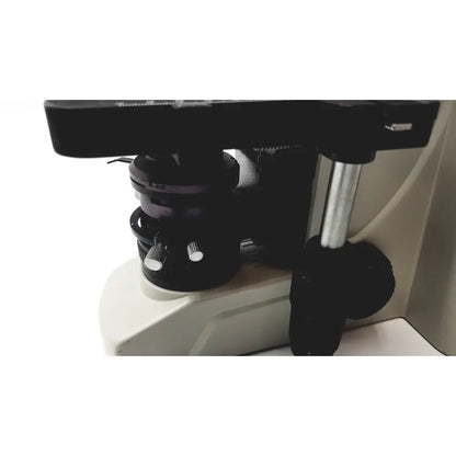 Black microscope stage with metallic adjustment knobs and silver vertical column on motic ba300 biological microscope tested model
