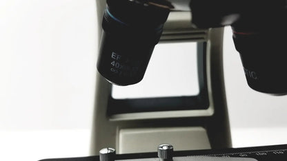 Black microscope objective lenses engraved ef 40x and infinity mounted on metallic stage of motic ba300 biological microscope tested