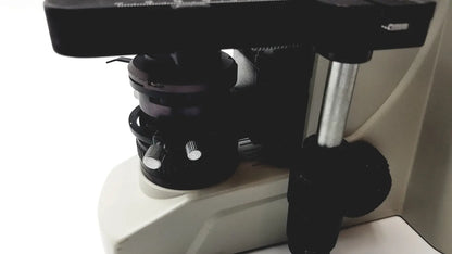 Black microscope stage with metallic adjustment knobs and silver vertical column on motic ba300 biological microscope tested model