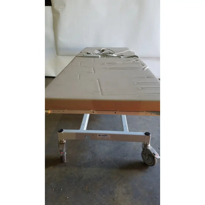 Gray mpi imaging table model 251 echo table with metal frame, wheels, and th2 handset for medical imaging use