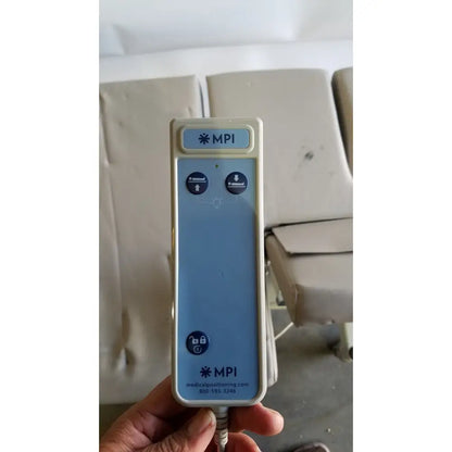 Light blue and beige mpi imaging table control panel with two circular buttons for position adjustment model 251 echo table