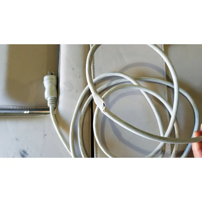 A white coiled power cable with a frayed end and intact plug for mpi imaging table model 251 echo table with th2 handset