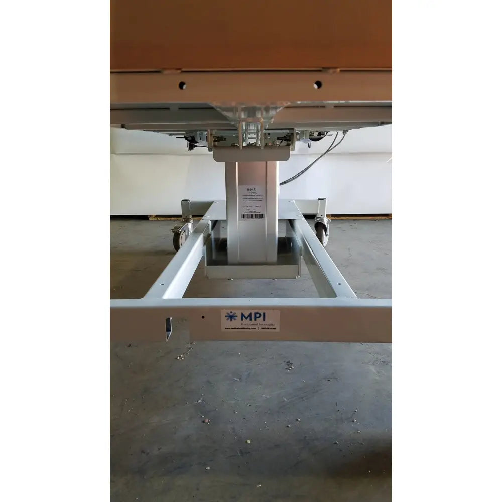 Silver metallic mpi imaging table model 251 with sturdy industrial design and wheels for mobility and imaging use