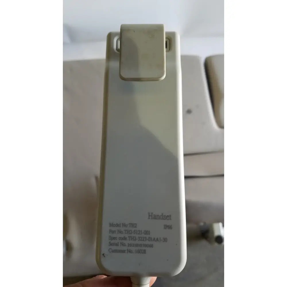 Beige plastic clip-top handset with printed specifications for mpi imaging table model 251 echo table with th2 handset