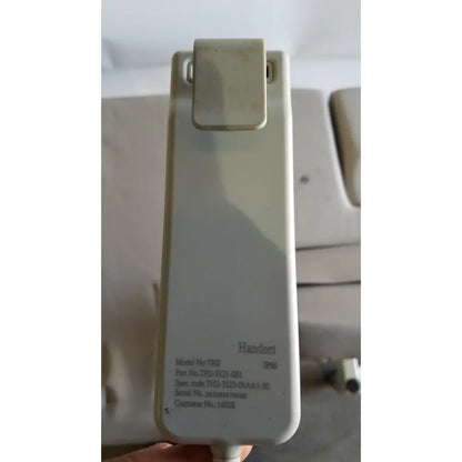Beige plastic clip-top handset with printed specifications for mpi imaging table model 251 echo table with th2 handset