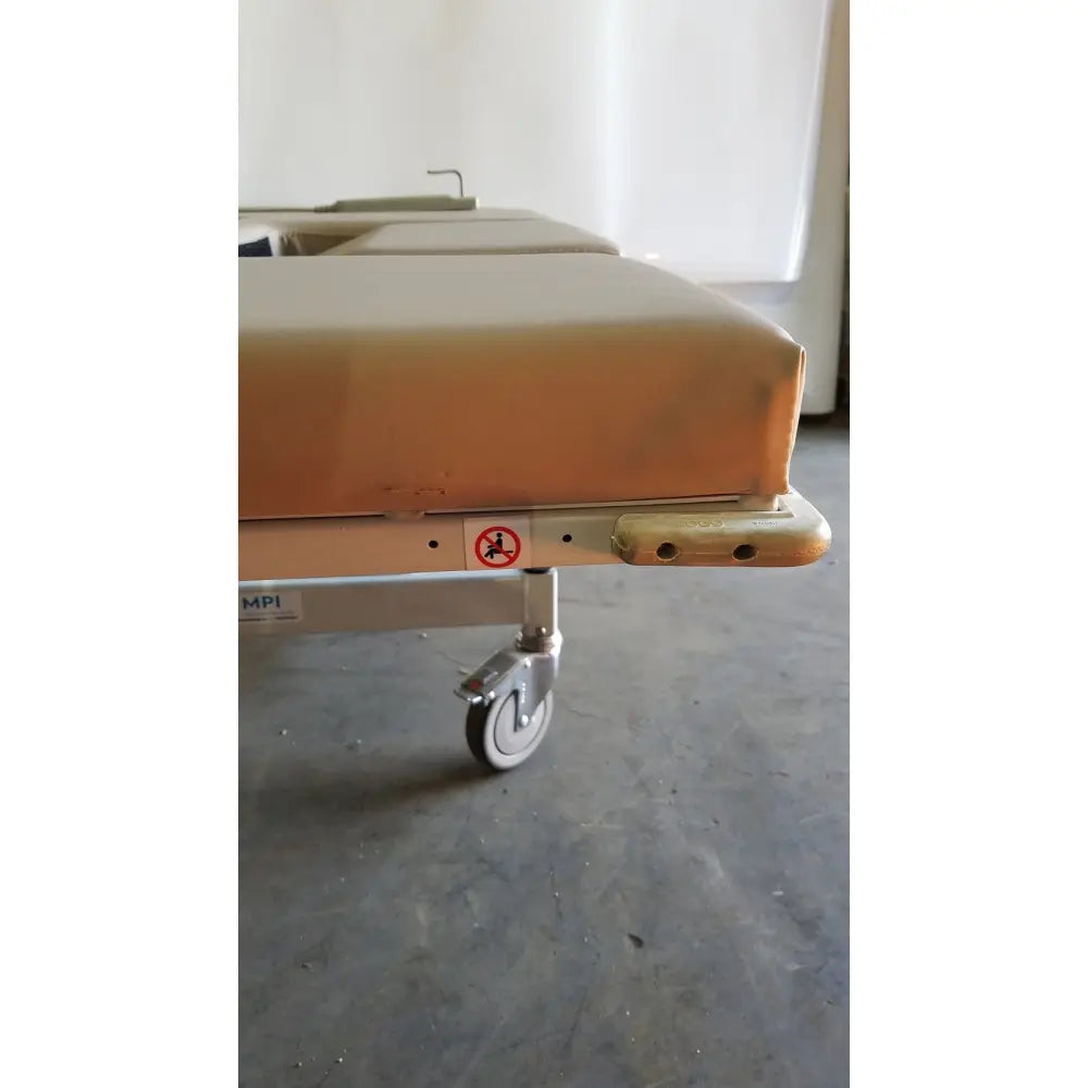 Beige padded mpi imaging table model 251 echo table with metal frame casters and th2 handset for medical use