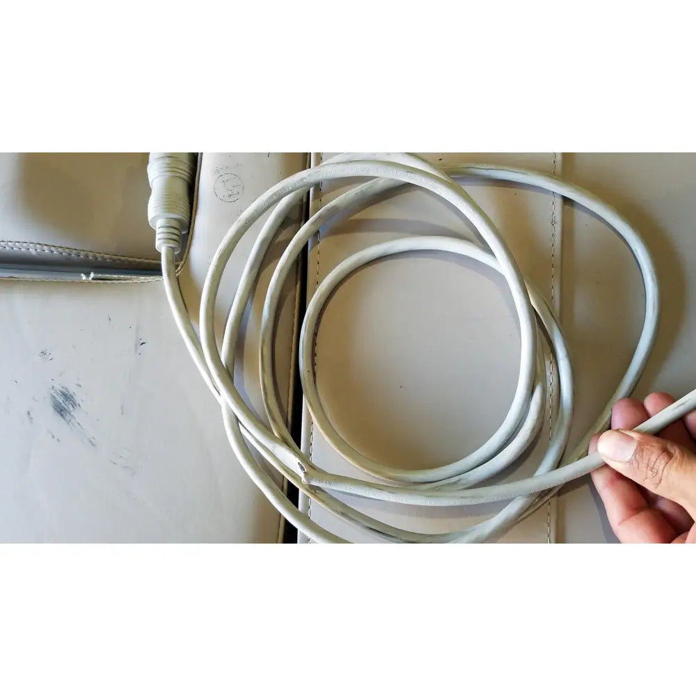 A coiled white usb cable with a matte finish for the mpi imaging table model 251 echo table with th2 handset