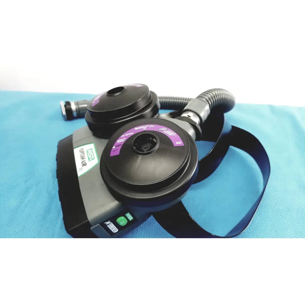 Black and gray msa optimair tl papr blower unit with purple dials, flexible hose, and adjustable straps for ventilation