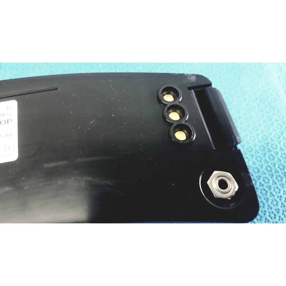 Black plastic msa optimair tl papr blower unit back side with three yellow contacts and hexagonal metal screw hole