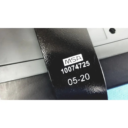 Black textured belt with white printed msa label and serial number for msa optimair tl papr blower unit with battery
