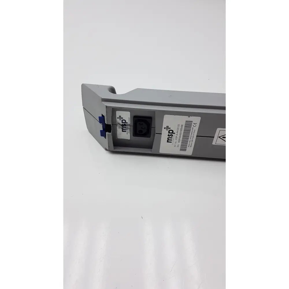Gray plastic msp battery 24v dc 4ah with black power input and blue locking mechanism for arjo models back side view
