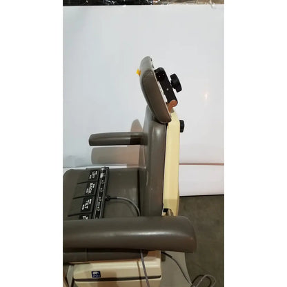 Beige and gray mti programmable podiatry chair with black foot control panels and adjustable features for clinical use
