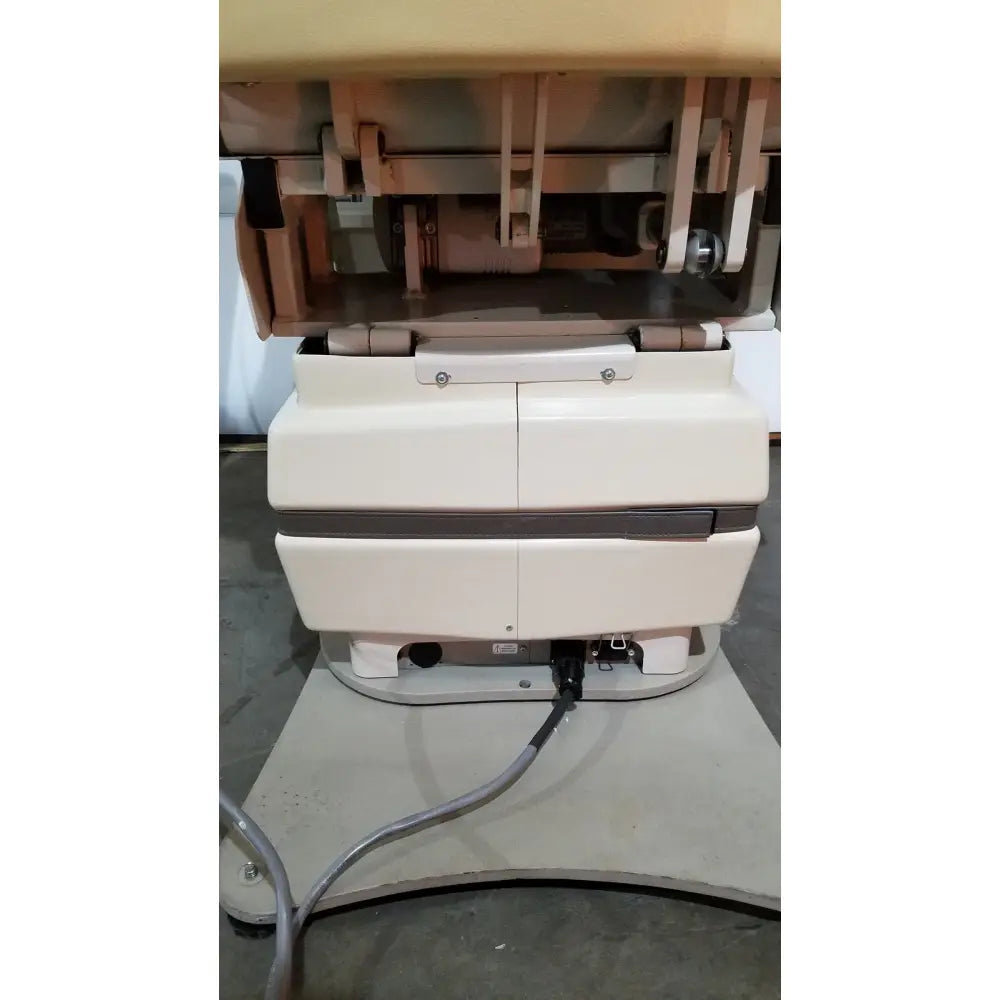 Cream-colored mti programmable podiatry chair with two doors dark brown stripe and metallic hardware for medical use
