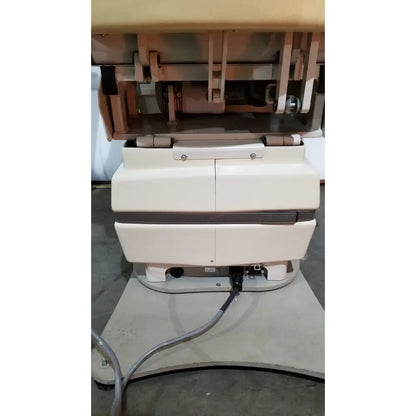 Cream-colored mti programmable podiatry chair with two doors dark brown stripe and metallic hardware for medical use