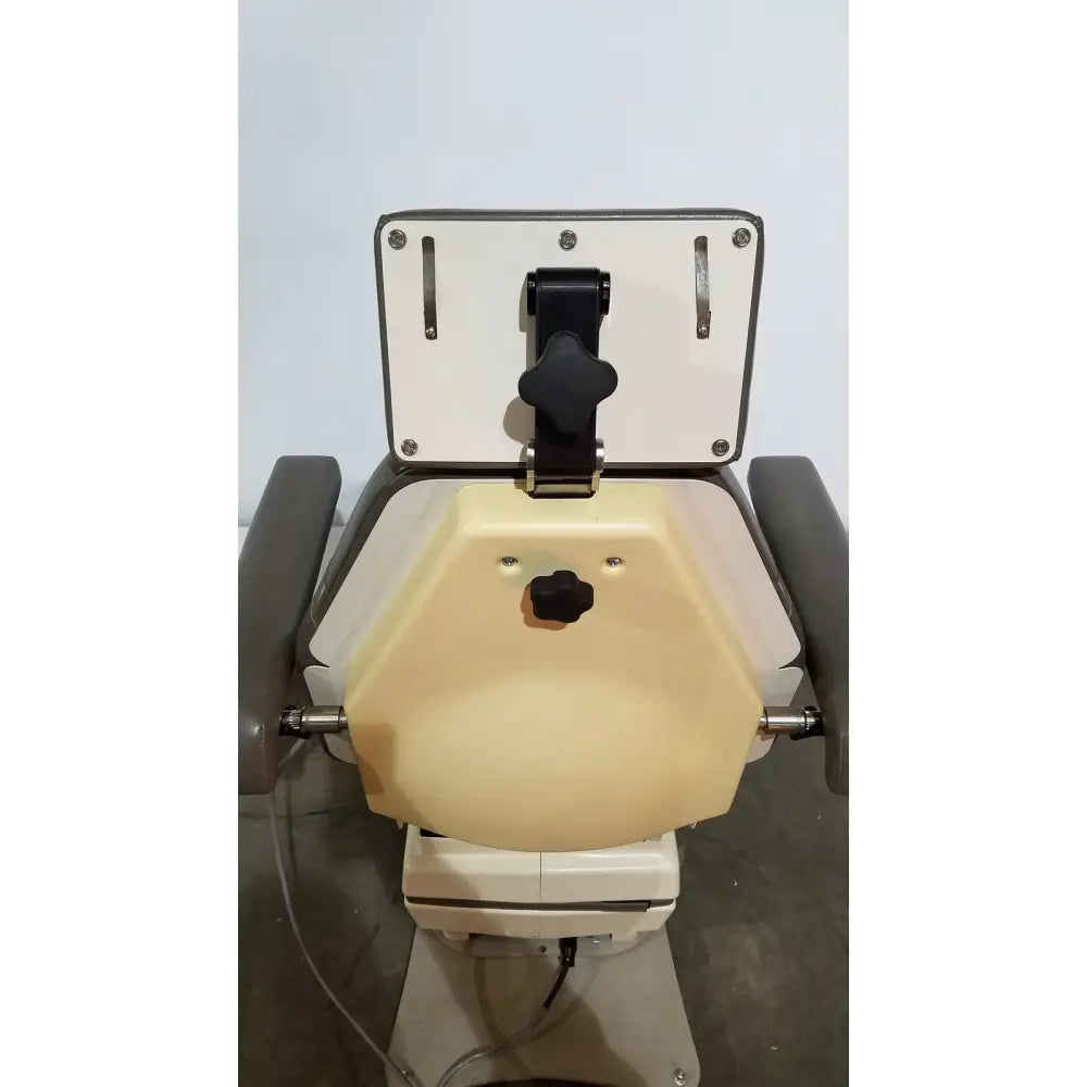 Medical dental chair of mti programmable podiatry chair with beige and gray upholstery and black adjustment knobs