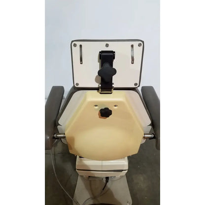 Medical dental chair of mti programmable podiatry chair with beige and gray upholstery and black adjustment knobs