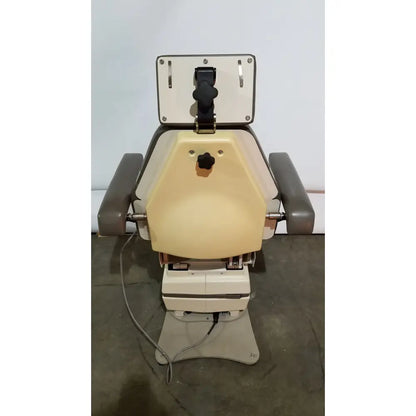 Beige and gray mti programmable podiatry chair with adjustable headrest armrests and foot control knobs
