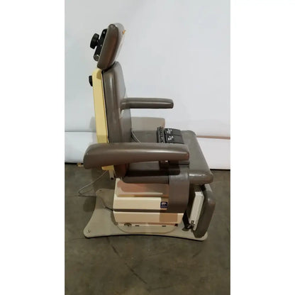 Brown and beige mti programmable podiatry chair with adjustable padded armrests headrest and foot control panel