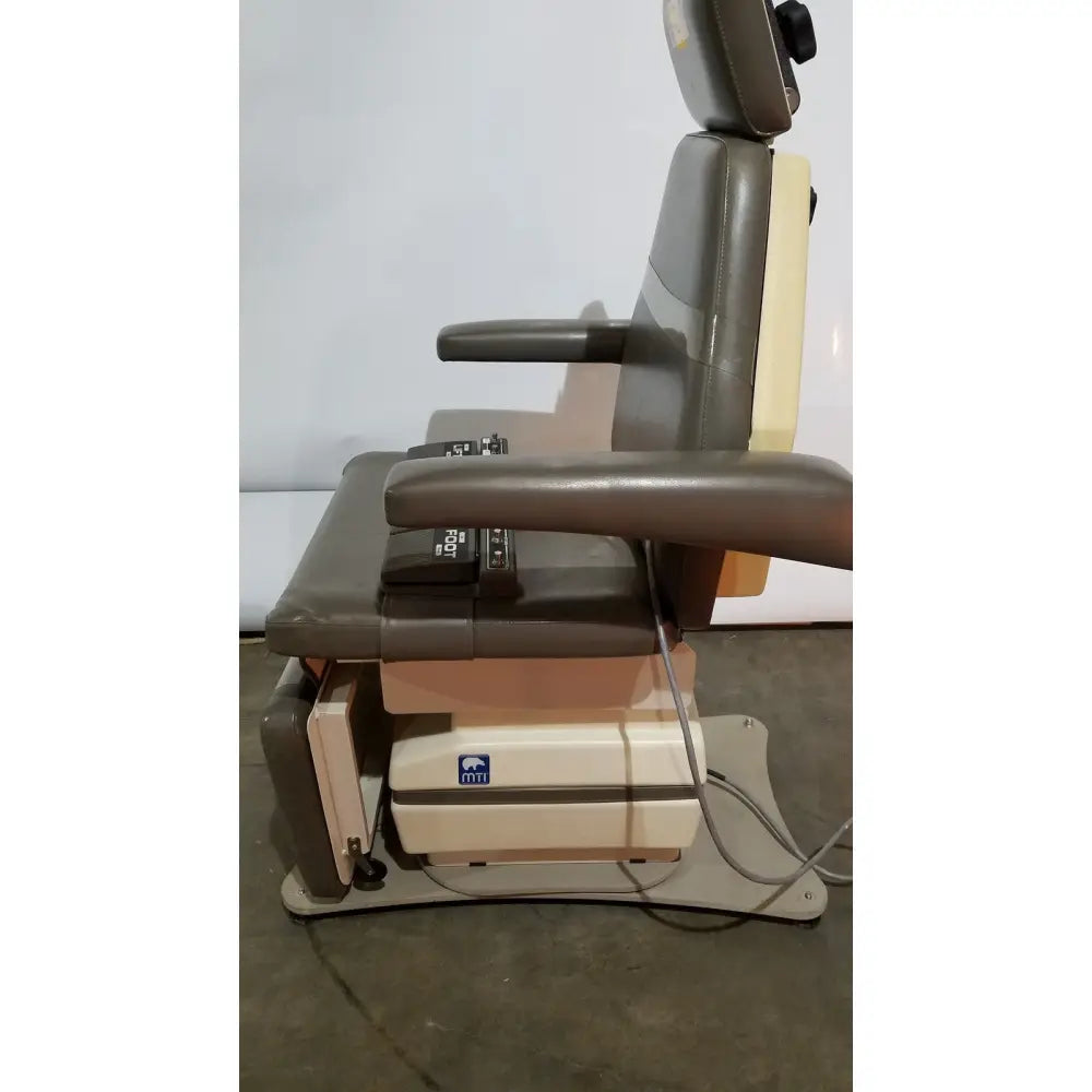 Adjustable mti programmable podiatry chair with dark gray and beige upholstery padded headrest armrests and seat control panel