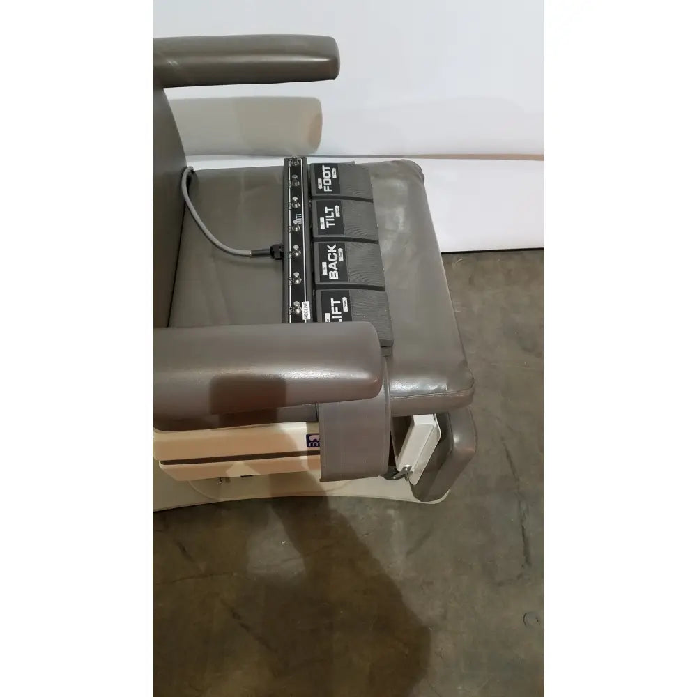 Gray leather mti programmable podiatry chair with black control panel featuring labeled adjustment buttons for back tilt and foot