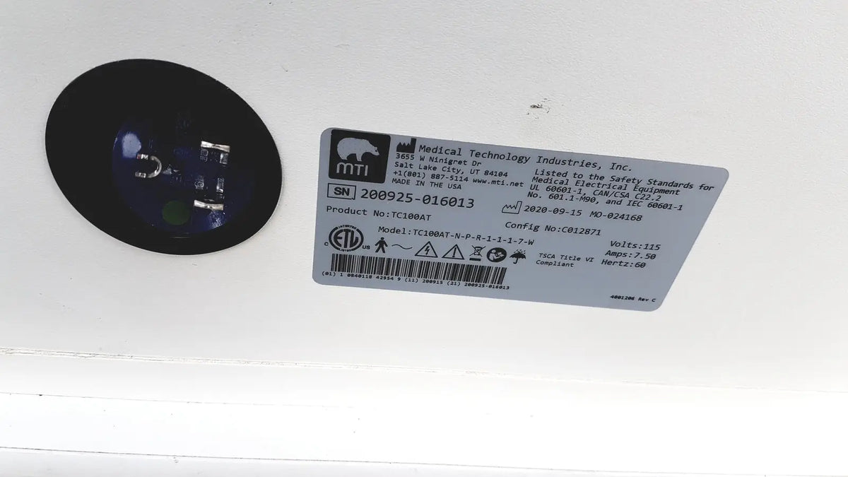 Black circular component with blue-tinted lens from mtt medical technology industries treatment cabinet tc100at