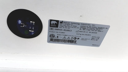 Black circular component with blue-tinted lens from mtt medical technology industries treatment cabinet tc100at